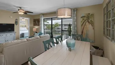 a dining room and living room with a table and chairs at Beachwood Villas 10C - A Wave From It All in Santa Rosa Beach