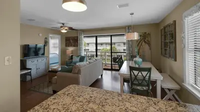 a living room with a couch and a table at Beachwood Villas 10C - A Wave From It All in Santa Rosa Beach