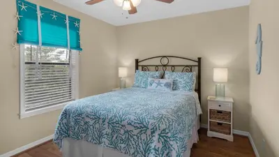 a bedroom with a bed and a window at Beachwood Villas 10C - A Wave From It All in Santa Rosa Beach