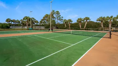 a tennis court with a net on top of it at Sand Cliffs 117 in Seacrest