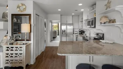 a kitchen with white walls and a marble counter top at Beachwood Villas 1D in Santa Rosa Beach