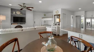 a kitchen and living room with a table and a couch at Beachwood Villas 1D in Santa Rosa Beach