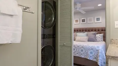 a bedroom with a bed and a shower with a mirror at Beachwood Villas 1D in Santa Rosa Beach