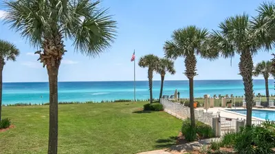 a view of the beach from a resort with palm trees at Sand Cliffs 214 in Seacrest
