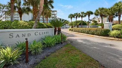 a sign for sand cities with palm trees and a street at Sand Cliffs 405 - Sunsets on the Bluff at Sand Cliffs in Seacrest