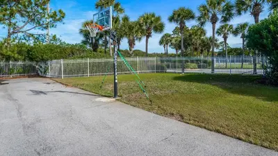 a basketball hoop in a park with a fence at Sand Cliffs 415 in Seacrest