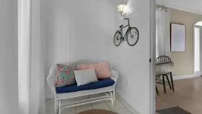 a room with a chair with a bike on the wall at A Slice of Lime in Santa Rosa Beach