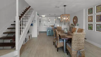a dining room and kitchen with a table and chairs at Dune Villas 5B - Sand In My Shoes in Santa Rosa Beach
