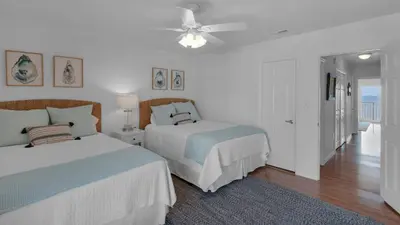 a bedroom with two beds and a ceiling fan at Dune Villas 5B - Sand In My Shoes in Santa Rosa Beach