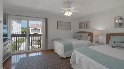 a bedroom with two beds and a balcony at Dune Villas 5B - Sand In My Shoes in Santa Rosa Beach