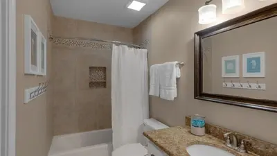 a bathroom with a tub and a sink and a shower at Dune Villas 5B - Sand In My Shoes in Santa Rosa Beach