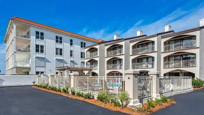 a large apartment building with a parking lot at Dune Villas 5B - Sand In My Shoes in Santa Rosa Beach