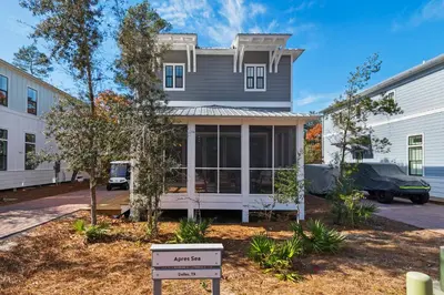 a house with a sign in front of it at Après Sea in Seacrest