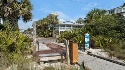 a house with a sign in front of a street at Intensive Care in Santa Rosa Beach