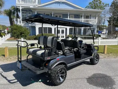 a golf cart parked in front of a house at Intensive Care in Santa Rosa Beach