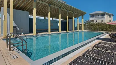 a large swimming pool with chairs in a building at Emerald Rose in Santa Rosa Beach
