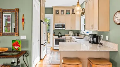 a kitchen with green walls and a counter top at Emerald Rose in Santa Rosa Beach
