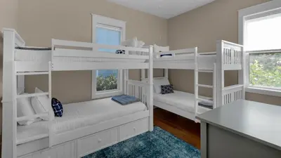 a room with white bunk beds and a window at 3 Mermaids Haven in Santa Rosa Beach