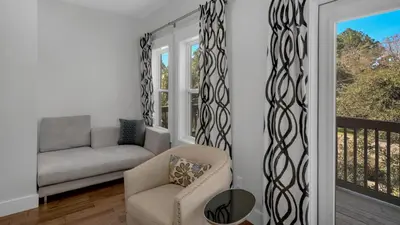 a living room with a couch and a chair at 3 Mermaids Haven in Santa Rosa Beach