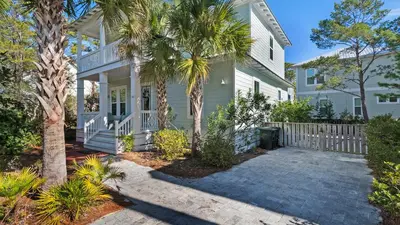 a white house with palm trees in front of it at 3 Mermaids Haven in Santa Rosa Beach
