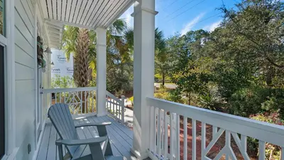 a blue chair sitting on the porch of a house at 3 Mermaids Haven in Santa Rosa Beach