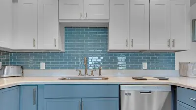 a kitchen with white cabinets and a sink at Blue Tide 6A in Panama City Beach