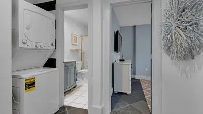 a bathroom with a sink and a refrigerator at Blue Tide 6A in Panama City Beach