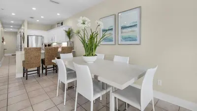 a dining room with a white table and chairs at Monterey Condos B402 in Panama City Beach
