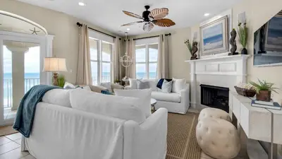 a living room with white furniture and a fireplace at Monterey Condos B402 in Panama City Beach