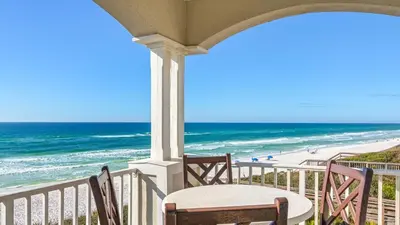 a porch with a table and chairs and the beach at Seaview I Unit 200 in Santa Rosa Beach