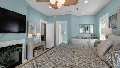 a living room with a bed and a flat screen tv at Seaview I Unit 200 in Santa Rosa Beach