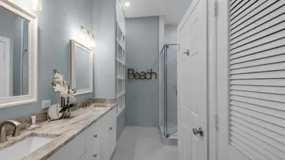 a white bathroom with two sinks and a shower at Village of S Walton 311F - Family Tides in Rosemary Beach