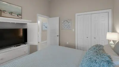 a bedroom with a bed and a flat screen tv at Village of S Walton 311F - Family Tides in Rosemary Beach
