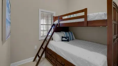a bedroom with two bunk beds and a ladder at Village of S Walton 311F - Family Tides in Rosemary Beach