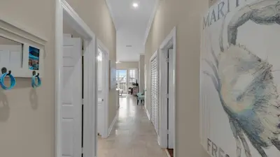 a hallway of a house with white walls and white floors at Village of S Walton 311F - Family Tides in Rosemary Beach