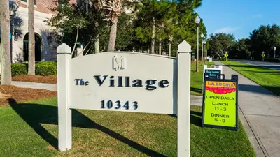 a sign that says the village in front of a building at Village of S Walton 311F - Family Tides in Rosemary Beach