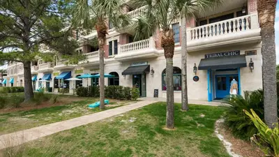 a building with palm trees in front of it at Village of S Walton 311F - Family Tides in Rosemary Beach