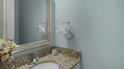 a bathroom with a sink and a mirror at Cassine Gardens 219 - Flamingo Retreat in Santa Rosa Beach