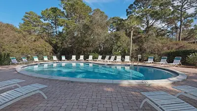 a swimming pool with chairs and a bunch ofitures at Cassine Gardens 219 - Flamingo Retreat in Santa Rosa Beach
