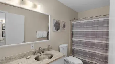 a bathroom with a sink and a toilet and a shower at Paradise Cottage Too in Santa Rosa Beach
