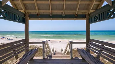 a wooden boardwalk to a beach with the ocean at Paradise Cottage Too in Santa Rosa Beach