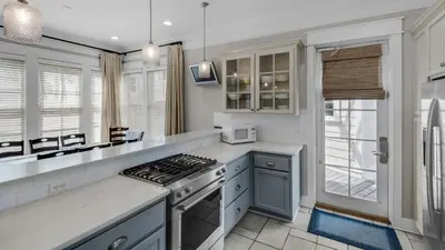 a kitchen with a stove top oven next to a window at Walking on Sunshine - Benchmark Management in Panama City Beach