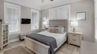 a bedroom with a bed and two windows at Walking on Sunshine - Benchmark Management in Panama City Beach