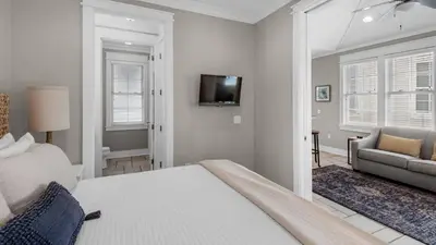 a bedroom with a bed and a couch and a television at Walking on Sunshine - Benchmark Management in Panama City Beach