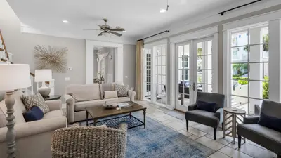 a living room with a couch and chairs at Walking on Sunshine - Benchmark Management in Panama City Beach