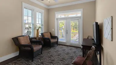a living room with two chairs and a television at Ocean Breeze in Santa Rosa Beach