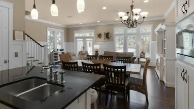 a kitchen and living room with a sink and a table at Ocean Breeze in Santa Rosa Beach