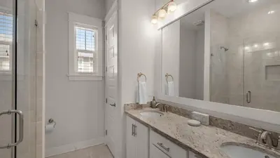 a bathroom with two sinks and a large mirror at Our Happy Place in Inlet Beach