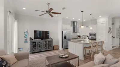 a kitchen and living room with a couch and a table at Our Happy Place in Inlet Beach