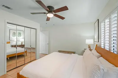 a bedroom with a bed and a ceiling fan at Capistrano E101 in Seacrest